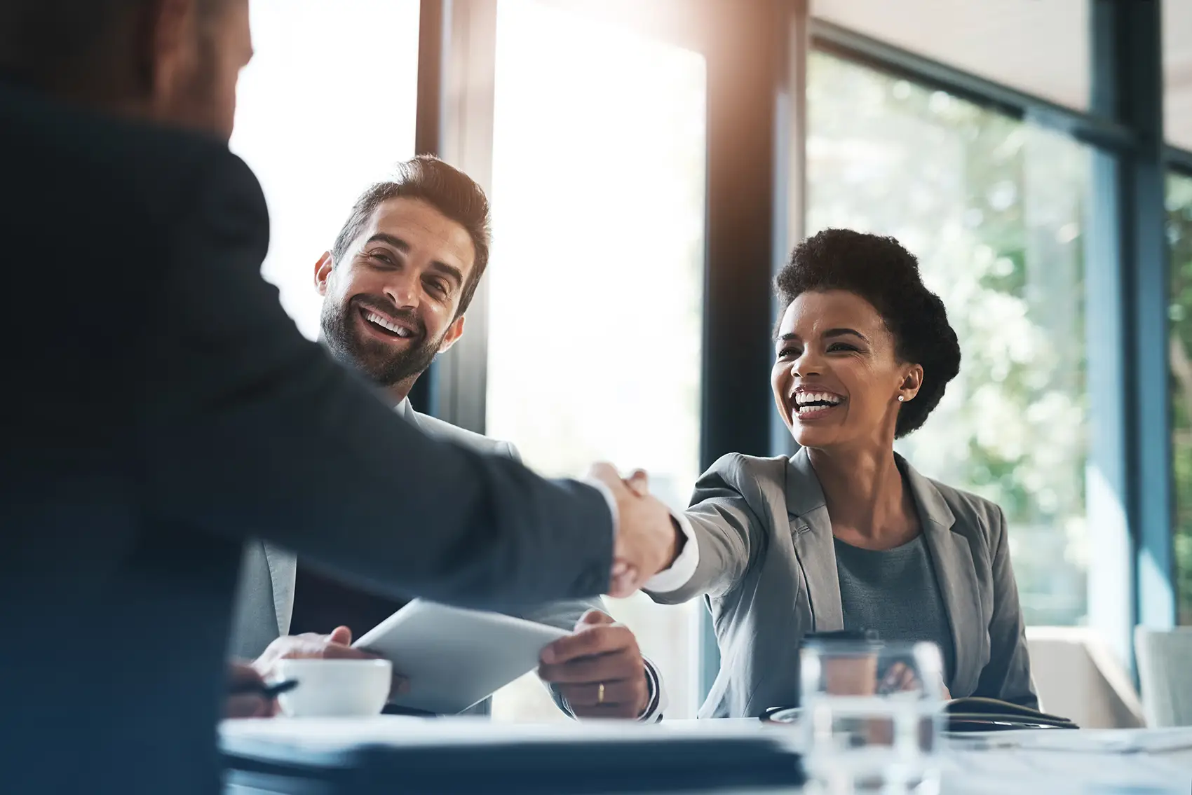 Smiling people shaking hands in an office